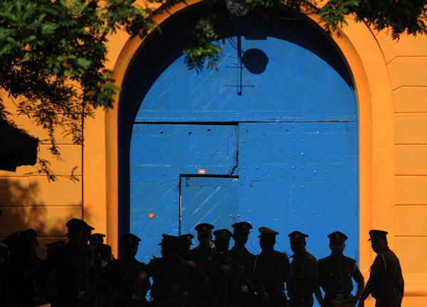 Sri Lankan policemen stand guard over prison