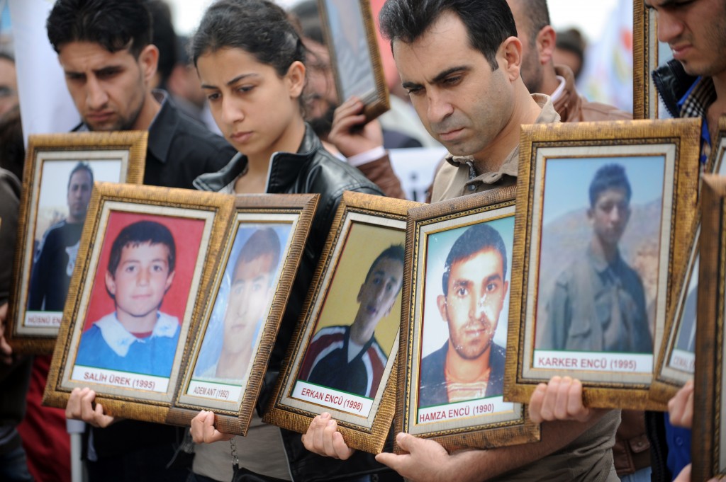 Kurdish people hold pictures of victims killed in a Turkish air raid during a demonstration on May 26, 2012, in Istanbul. (Photo credit BULENT KILIC/AFP/GettyImages)