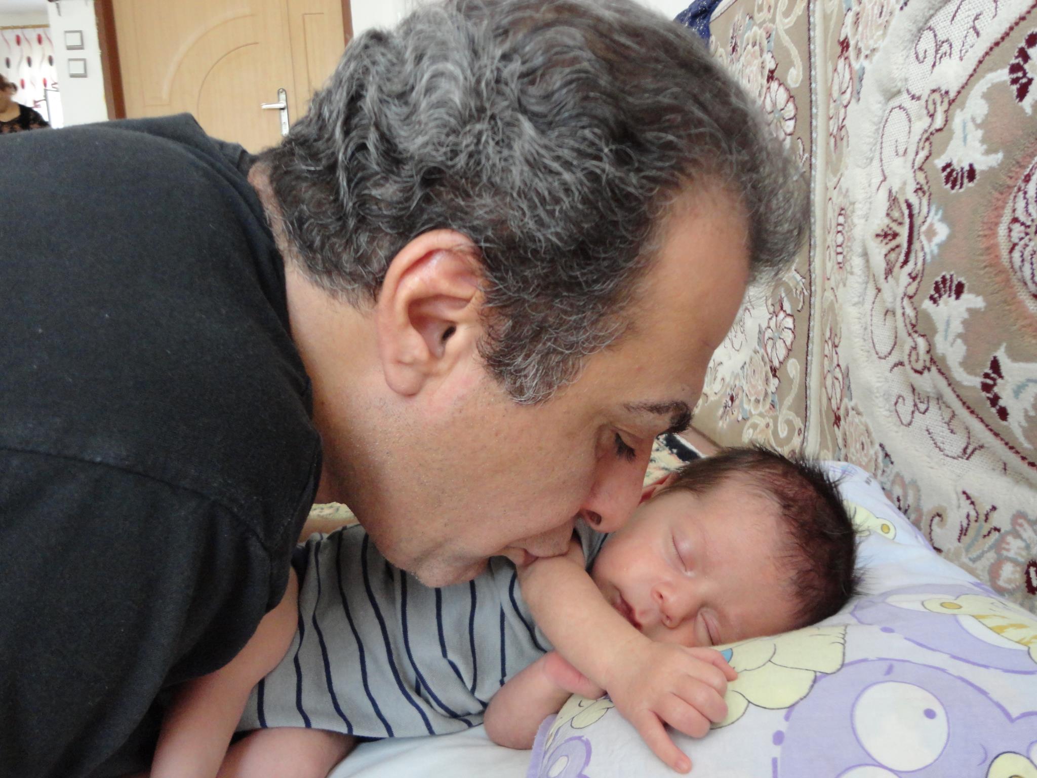 Behrouz with his newborn son, Harmang