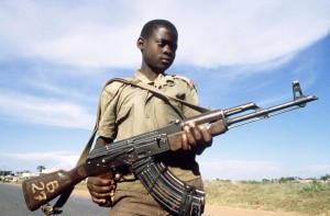 National Resistance Army child soldier poses with his kalashnikov.  (Photo credit: Dominique Aubert/AFP/Getty Images)