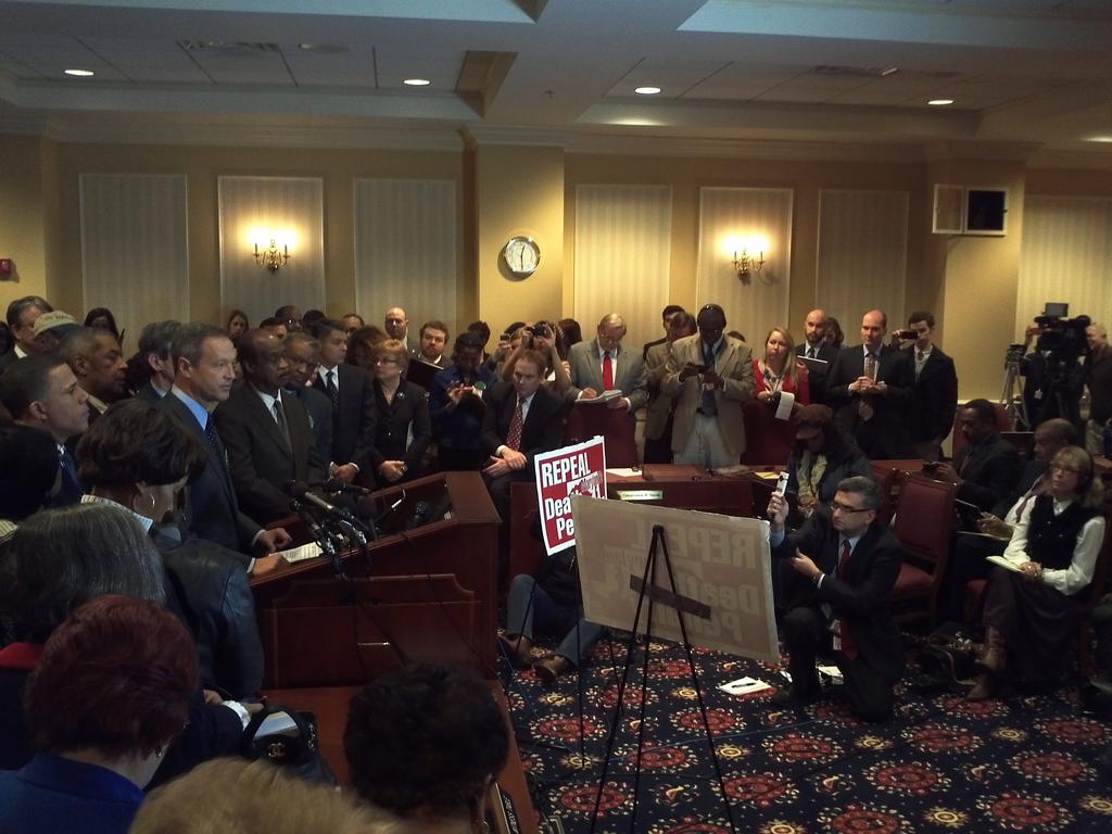 Maryland Governor Martin O'Malley speaks for death penalty repeal,  surrounded by supporters and the media. 