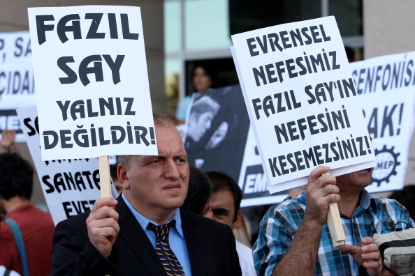 Supporter of Turkish pianist Fazil Say holds a sign in support of Say.