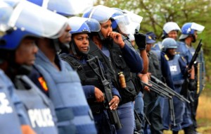 South African police  block a march by protesting miners in Rustenburg after a security crackdown in the restive platinum belt where officers shot dead 34 strikers (Photo Credit: Alexander Joe/AFP/GettyImages).