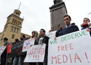 People hold posters as they mark World Press Freedom Day in Tbilisi (Photo Credit: Vano Shlamov/AFP/GettyImages).