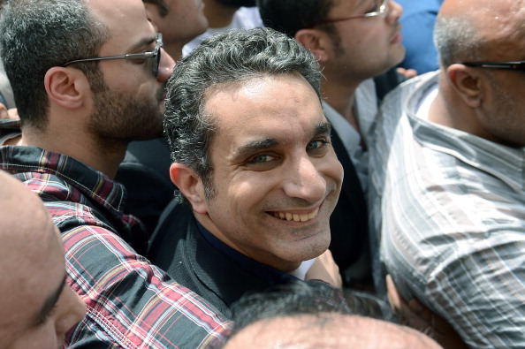 Egyptian satirist and television host Bassem Youssef surrounded by his supporters upon his arrival at the public prosecutor's office in the high court in Cairo.  Egypt's public prosecutor ordered the arrest of popular satirist Youssef over alleged insults to Islam and to President Mohamed Morsi, in the latest clampdown on critical media (Photo Credit: Khaled Desouki/AFP/Getty Images).