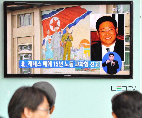 Passersby watch a television broadcast in Seoul showing a picture of Kenneth Bae, a Korean-American tour operator detained in North Korea, and sentenced to 15 years' hard labor for &quot;hostile acts&quot; (Photo Credit: Kim Jae-Hwan/AFP/Getty Images).