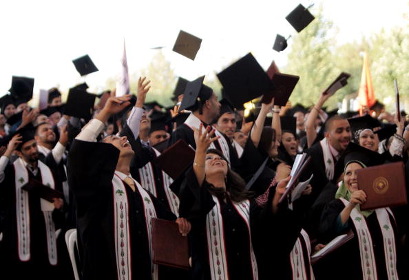 Palestinian students celebrate during their graduation ceremony at Birzeit University. Birzeit is the university of choice for Azza, Suhair and Loujain. However, like many Palestinian students, they are restricted from attending because the university is in the West Bank and they live in Gaza (Photo Credit: Abbas Momani/AFP/Getty Images).