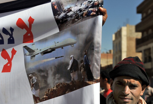 A Yemeni hold up a banner during a protest against U.S. drone attacks on Yemen close to the home of Yemeni President Abdrabuh Mansur Hadi. Strikes by U.S. drones in Yemen nearly tripled in 2012 compared to 2011 (Photo Credit: AFP/Getty Images).