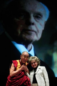 The Dalai Lama and Annette Lantos in front of a projection of the late U.S. Representative Tom Lantos. The Tom Lantos Human Rights Commission (TLHRC) was one of the creators of the Defending Freedoms Project (Photo Credit: Mark Wilson/Getty Images).