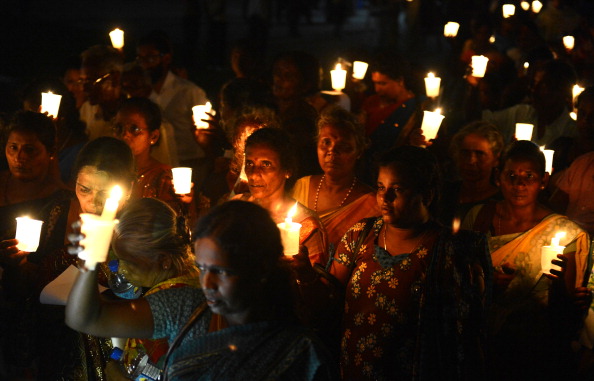 Activists hold lighted candles during a vigil on International Day of the Disappeared in Sri Lanka, where some 12,000 complaints of enforced disappearances have been submitted to the U.N. since the 1980s (Photo Credit: Lakruwan Wanniarachchi/AFP/Getty Images).