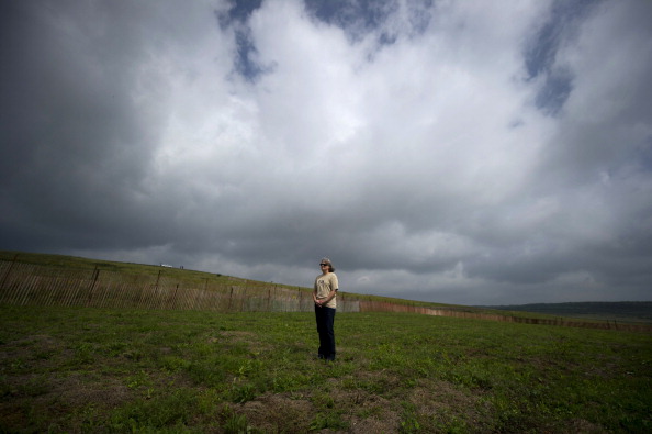 Sherry Chamberlain, 57, of Jumonville, PA, stands in a field during the dedication ceremony for the Flight 93 National Memorial September 10, 2011 in Shanksville, Pennsylvania (Photo Credit: Jeff Swensen via Getty Images).
