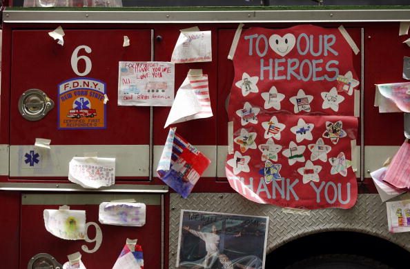 Drawings made by children decorate a New York City fire truck on Broadway near the scene of the World Trade Center wreckage, September 27, 2001, New York City (Photo Credit: Stand Honda, AFP via Getty Images).
