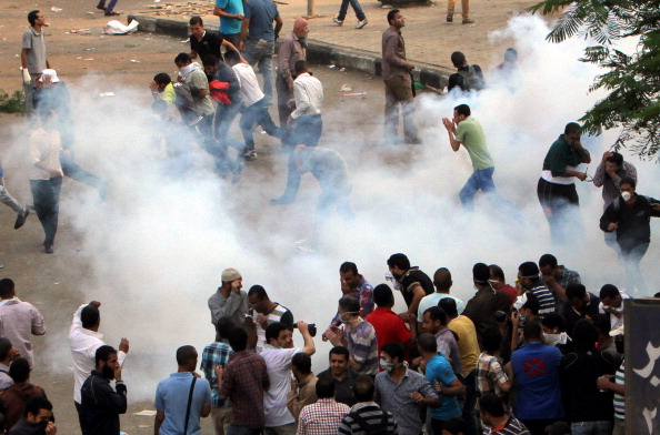 Egyptian security forces used tear gas to disperse pro-democracy activists during protests marking the 40th anniversary of the 1973 victory over the Israeli army at Ramses Square on October 6, 2013 in Cairo, Egypt (Photo by Salah Said/Anadolu Agency/Getty Images).