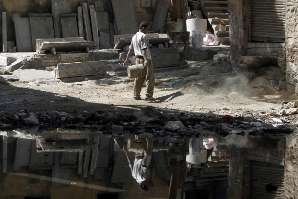 An Egyptian man works at a Cairo slum. Forty percent of Egyptians live on two dollars a day or less, according to the World Bank. Unemployment is rife among the young, forcing many to put off marriage and children until well into their 30s. (Photo Credit: Mahmud Hams/AFP/Getty Images).