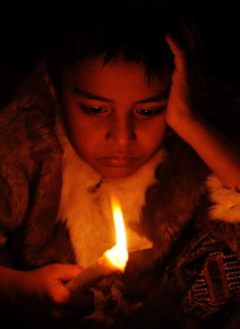 A child holds a candle during a vigil on the 25th anniversary of the world's worst industrial accident in Bhopal (Photo Credit: Indranil Mukherjee/AFP/Getty Images).