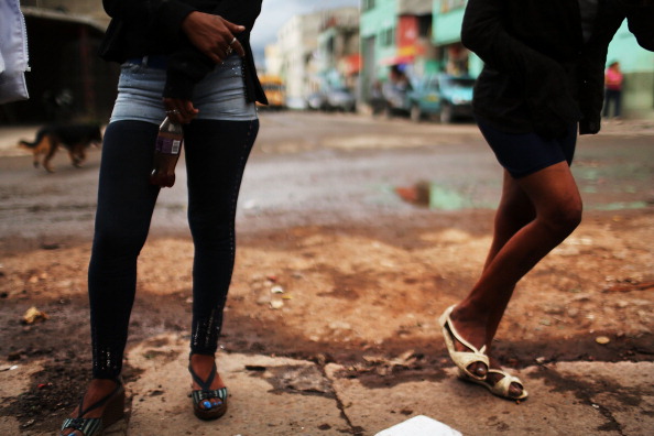 Sex workers wait for customers in Honduras. Honduras now has the highest per capita murder rate in the world and its capital city, Tegucigalpa, is plagued by violence, poverty, homelessness and sexual assaults (Photo Credit: Spencer Platt/Getty Images).