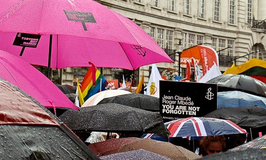 Showing solidarity with Roger Jean-Claude Mbede at a rainy London Pride in 2012 © I Uppal 
