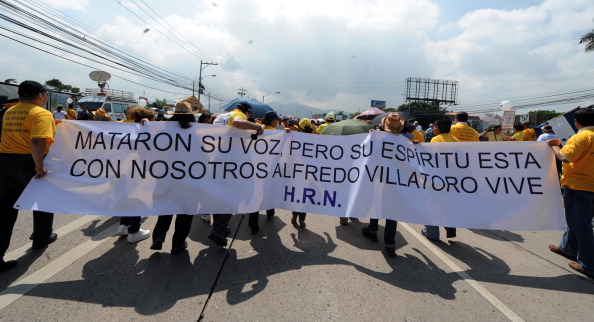 Journalists, journalism students and relatives of slain journalists take part in a demonstration during the celebration of the Day of the Journalist in Tegucigalpa, Honduras (Photo Credit: Orlando Sierra/AFP/Getty Images).