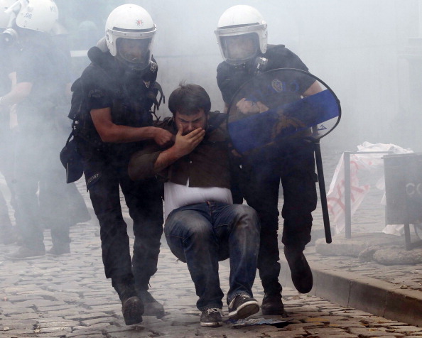 Turkish police arrest a protester during a demonstration after more than 200 people were killed in an explosion at a mine (Photo Credit: Adem Altan/AFP/Getty Images).