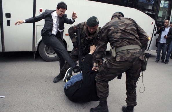 Yusuf Yerkel, advisor to Turkish Prime Minister Recep Tayyip Erdogan, kicking a protester already held by special forces police members during Erdogan's visit to Soma, Turkey (Photo Credit: Depo Photos/AFP/Getty Images).