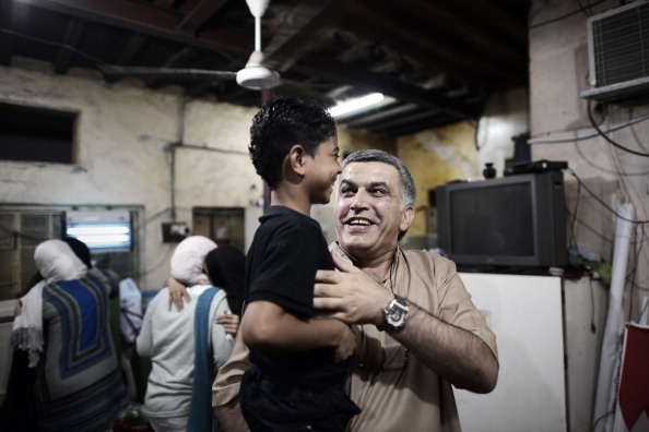 Nabeel Rajab carries the son of Abdul Aziz al-Abbar, a Bahraini man who died from his wounds on February 23 after he was shot during clashes between police and protesters (Photo Credit: Mohammed Al-Shaikh/AFP/Getty Images).