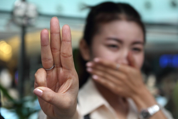 Protester raise three fingers representing liberty, brotherhood and equality during an anti-coup demonstration in Bangkok (Photo Credit: Piti A Sahakorn/LightRocket via Getty Images).