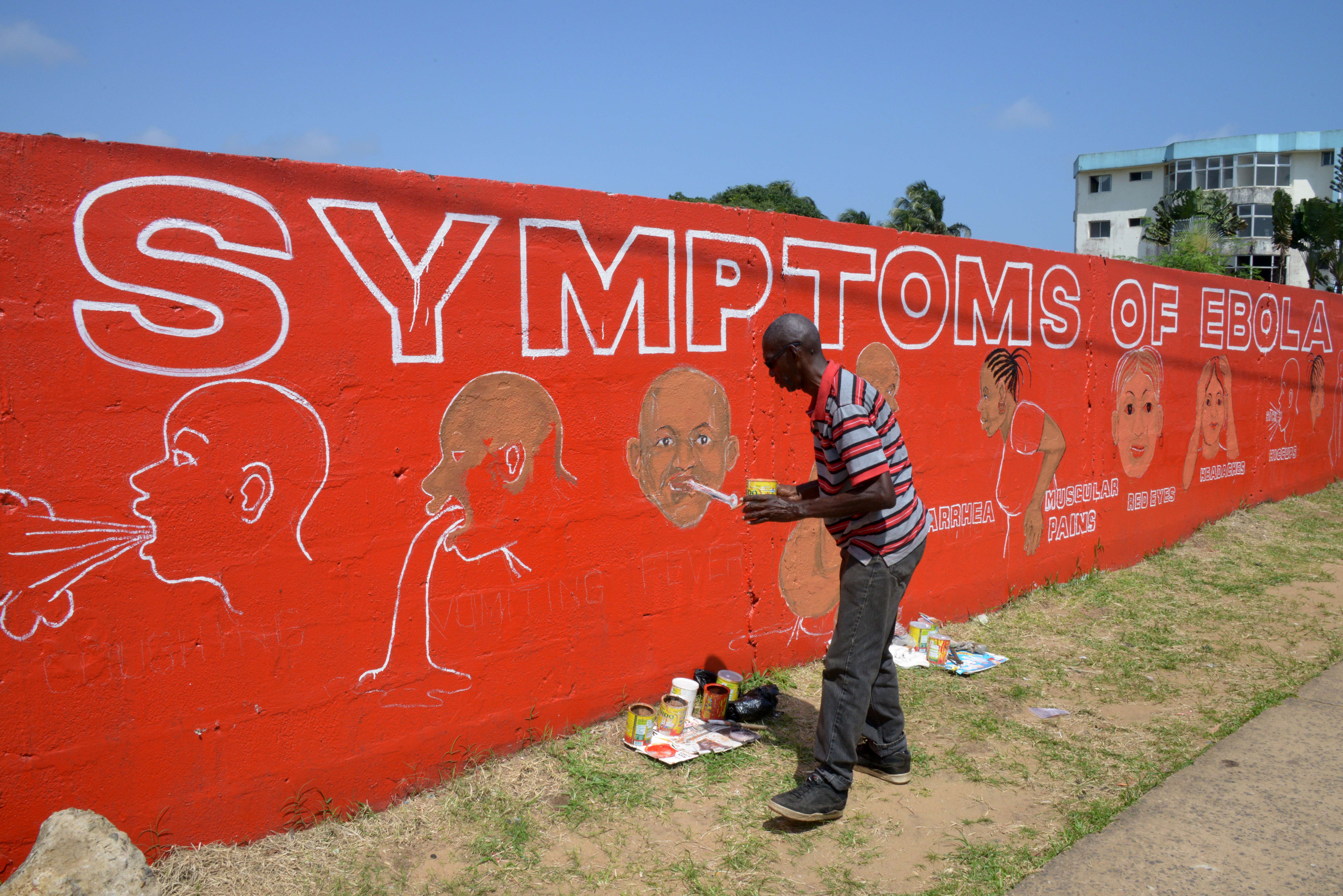 A street artist, Stephen Doe, paints an educational mural to inform people about the symptoms of the deadly Ebola virus in the Liberian capital Monrovia    ( DOMINIQUE FAGET/AFP/Getty Images)
