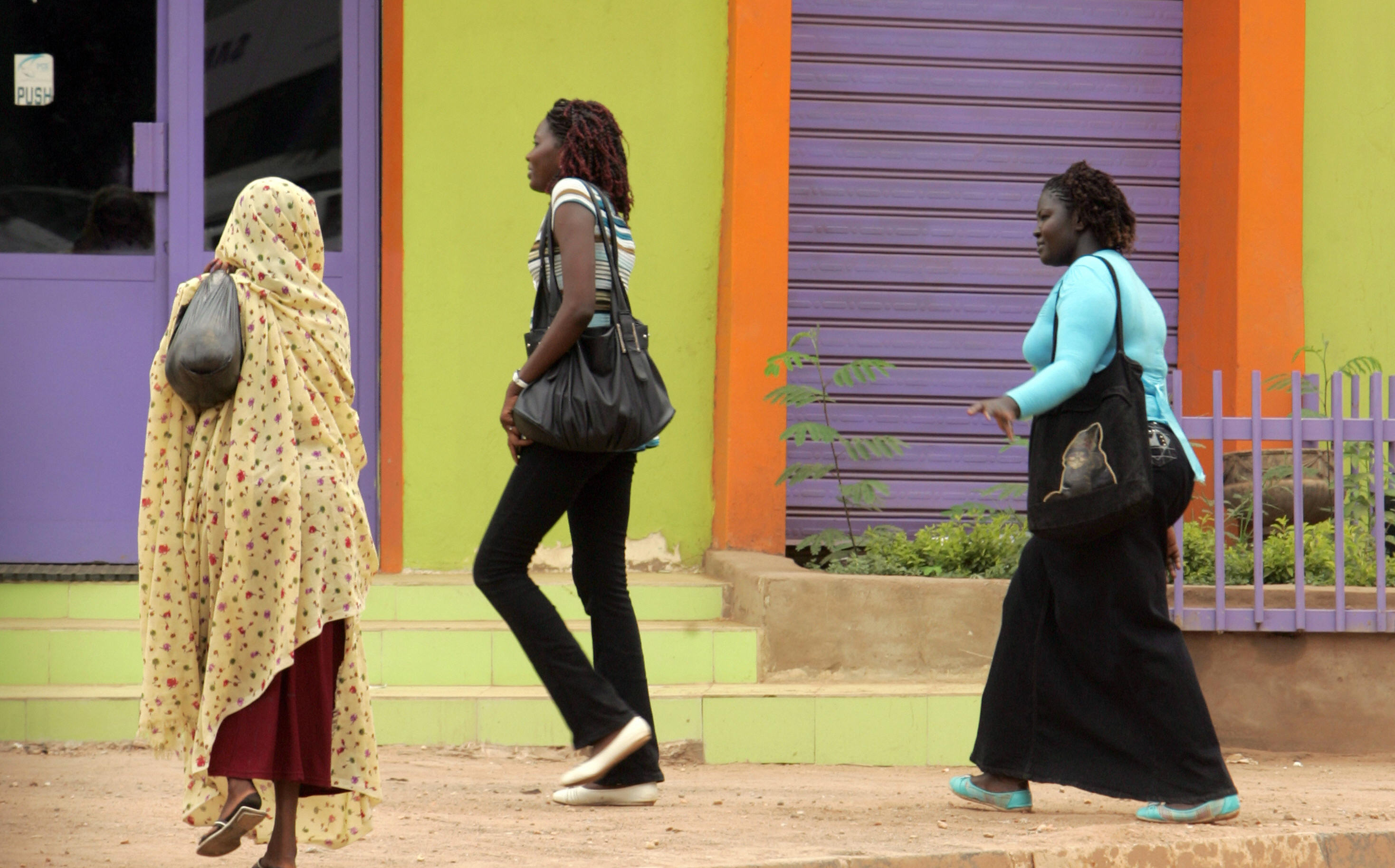 Three Sudanese women, one of them wearing trousers, walk on a main street in central Khartoum on September 8, 2009. The thousands of women who wear trousers every day all run the risk of a flogging if police decide their clothes are provocative. ASHRAF SHAZLY/AFP/Getty Images