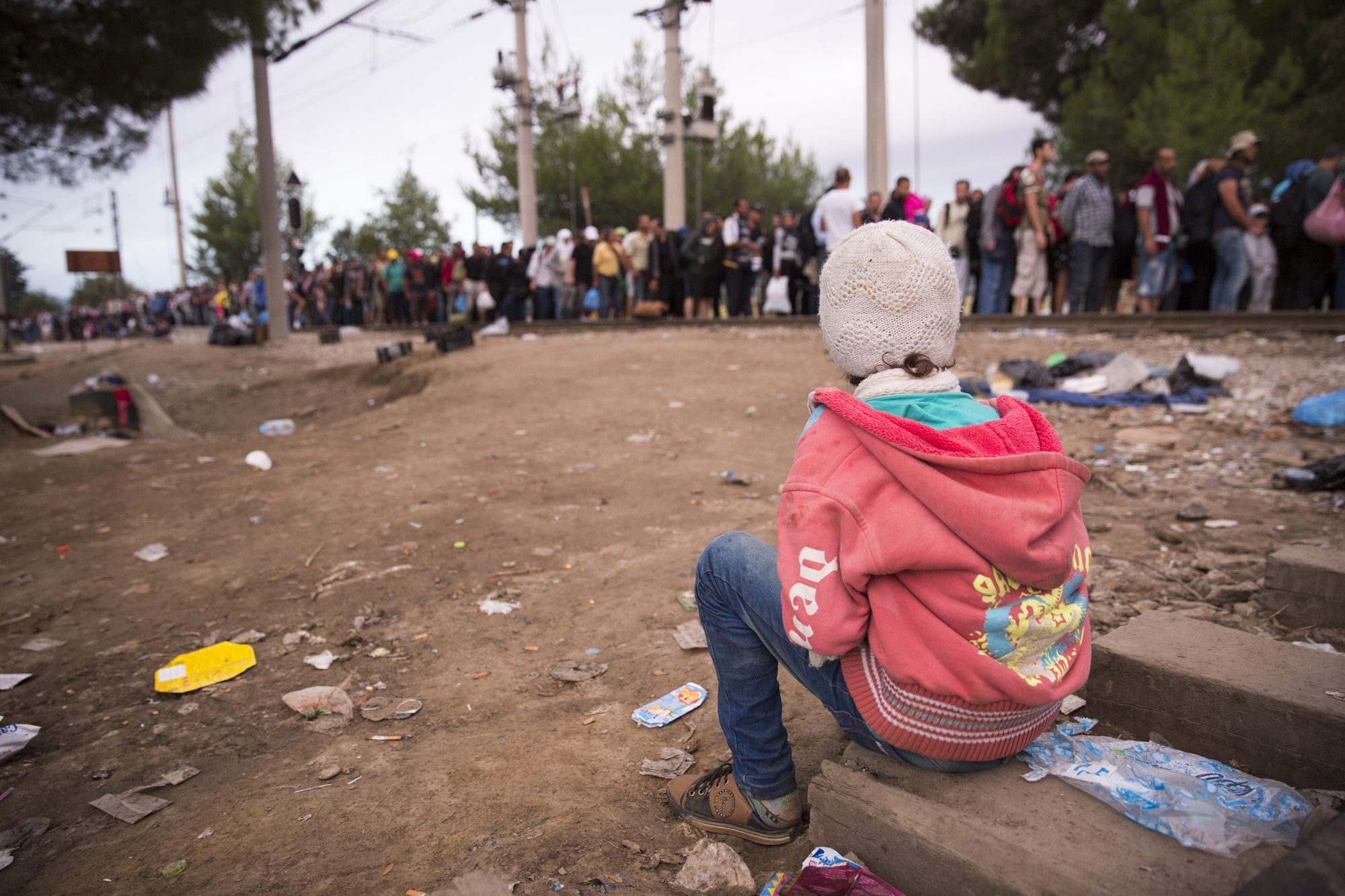 Refugees and migrants wait at the Macedonia border near the village of Idomeni, Greece, 24 August 2015.