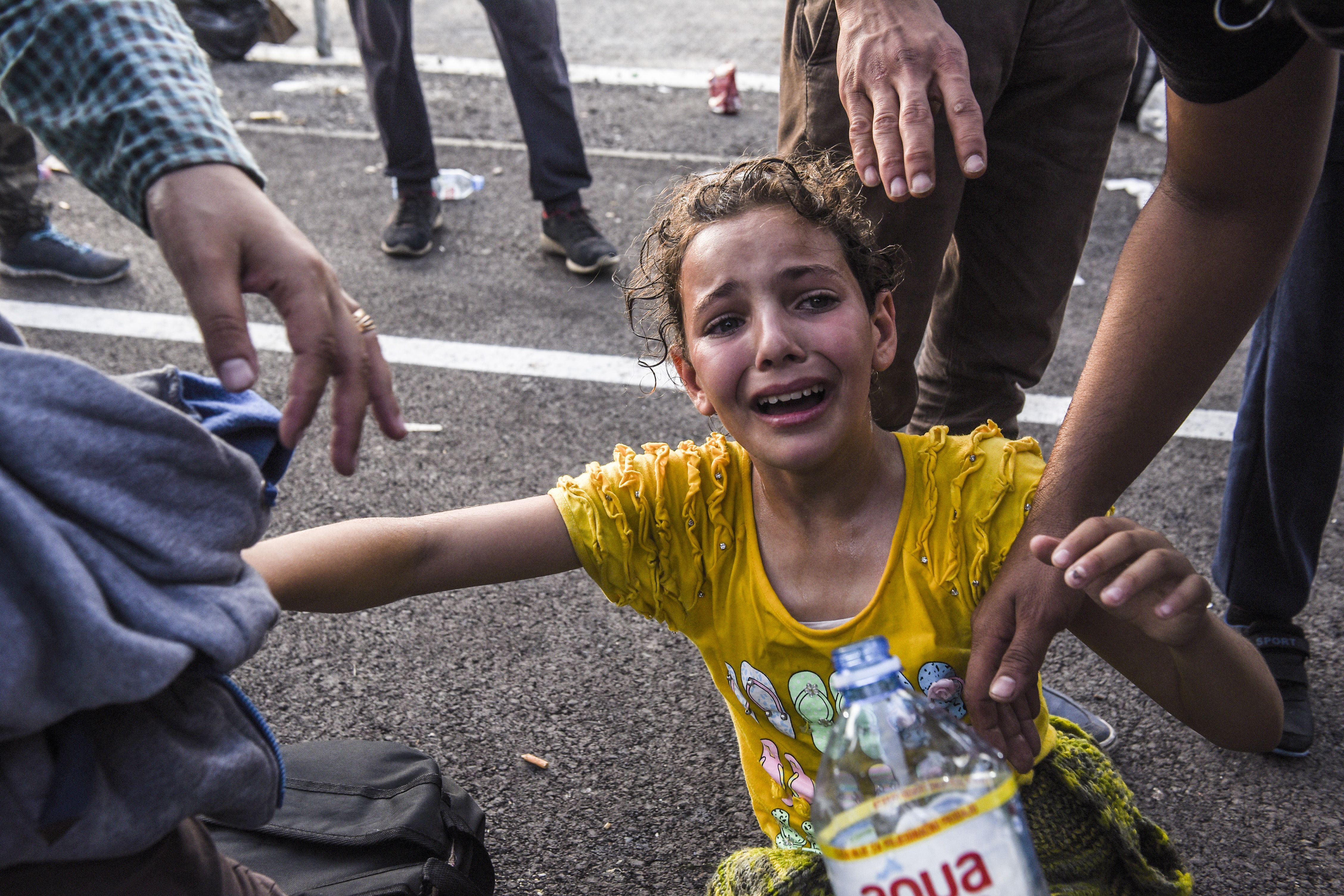A girl reacts after receiving tear gas at the Hungarian border with Serbia. ARMEND NIMANI/AFP/Getty Images