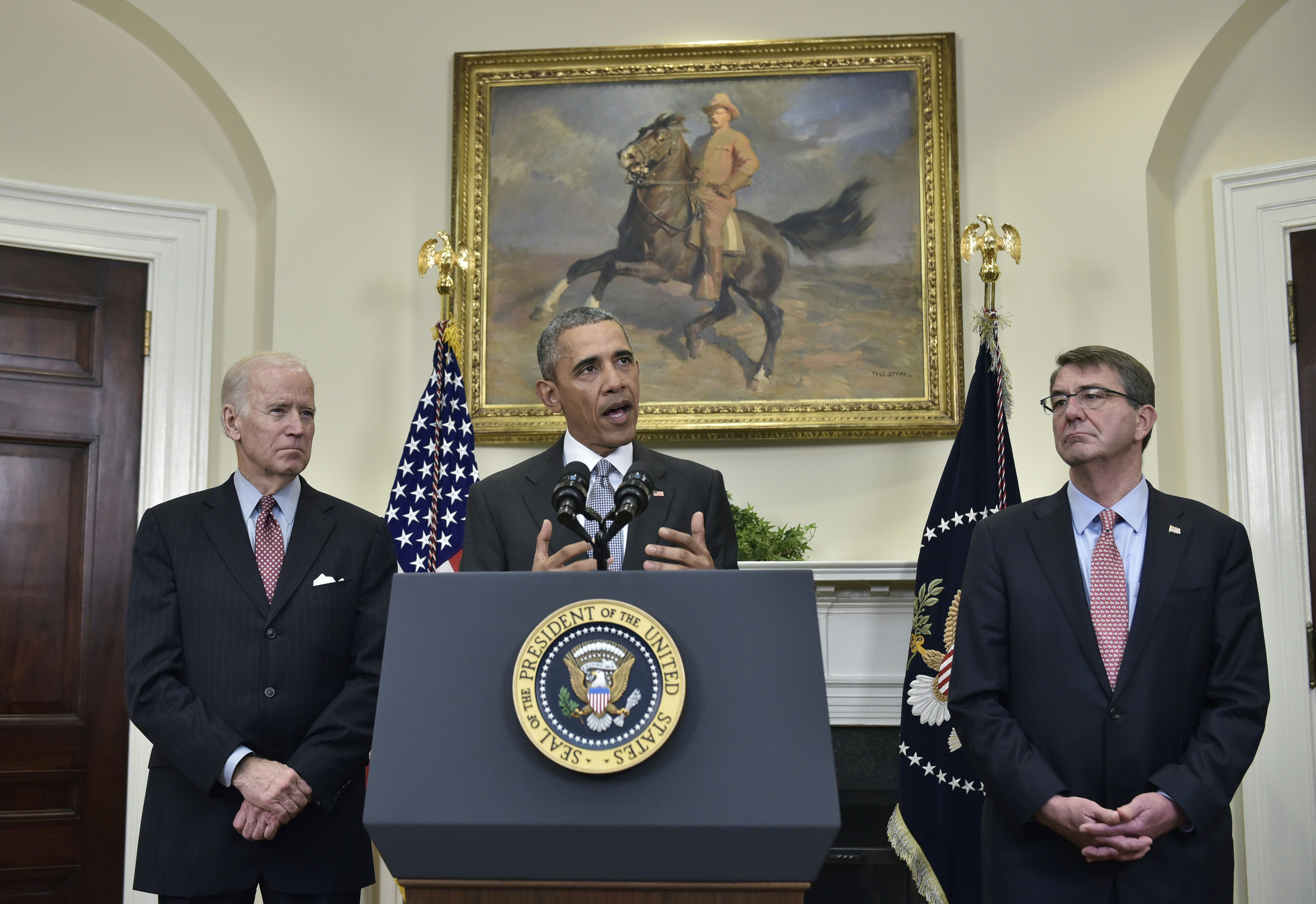 US President Barack Obama delivers a statement on the Guantanamo Bay detention camp flanked by US Vice President Joe Biden (L) and Defense Secretary Ashton Carter on February 23, 2016 in the Roosevelt Room of the White House in Washington, DC. President Barack Obama on February 23 took his case for closing the Guantanamo military prison to the American people, saying it was time to shutter a facility that betrayed US interests and values. A total of 91 suspected jihadists remain at Guantanamo, a prison that once housed about 700 inmates at its peak and has become synonymous around the world with torture, indefinite detention and orange jumpsuits. / AFP / Mandel Ngan        (Photo credit should read MANDEL NGAN/AFP/Getty Images)