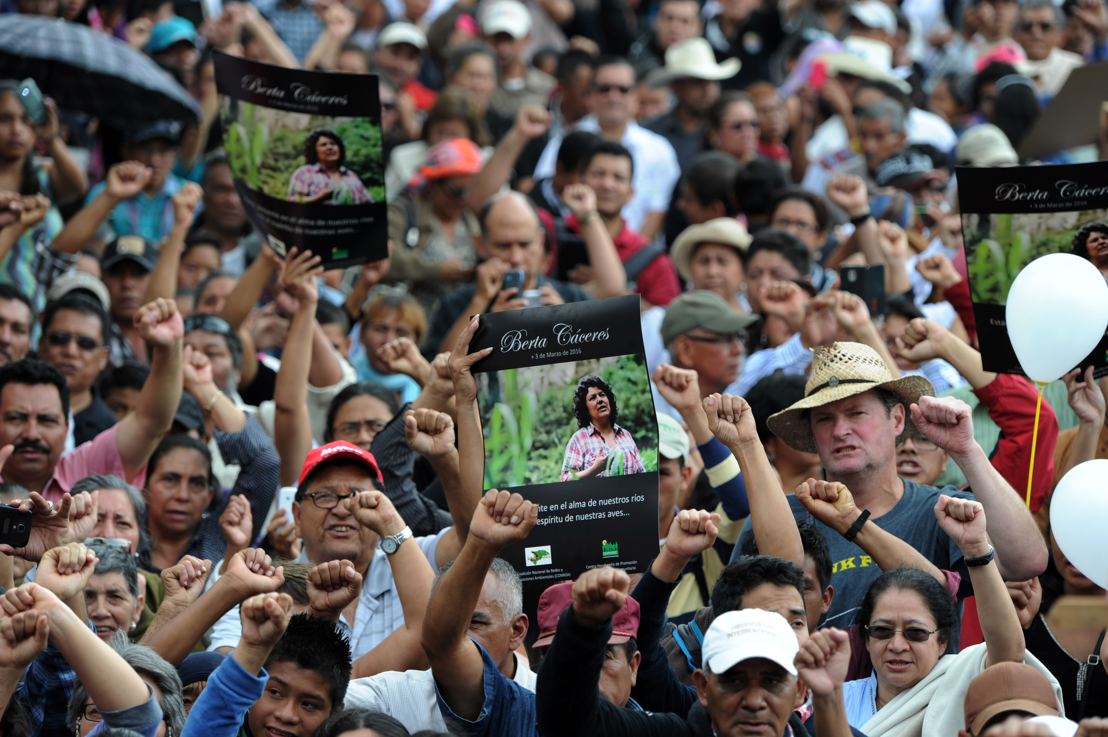 People attend the funeral of murdered indigenous activist Berta Caceres, in La Esperanza, 200 km northwest of Tegucigalpa, on March 5, 2016. Honduran indigenous activist Berta Caceres, a renowned environmentalist whose family has labeled her killing an assassination, was shot dead on March 3 at her home in La Esperanza. Caceres rose to prominence for leading the indigenous Lenca people in a struggle against a hydroelectric dam project that would have flooded large areas of native lands and cut off water supplies to hundreds.  AFP PHOTO / ORLANDO SIERRA / AFP / ORLANDO SIERRA        (Photo credit should read ORLANDO SIERRA/AFP/Getty Images)