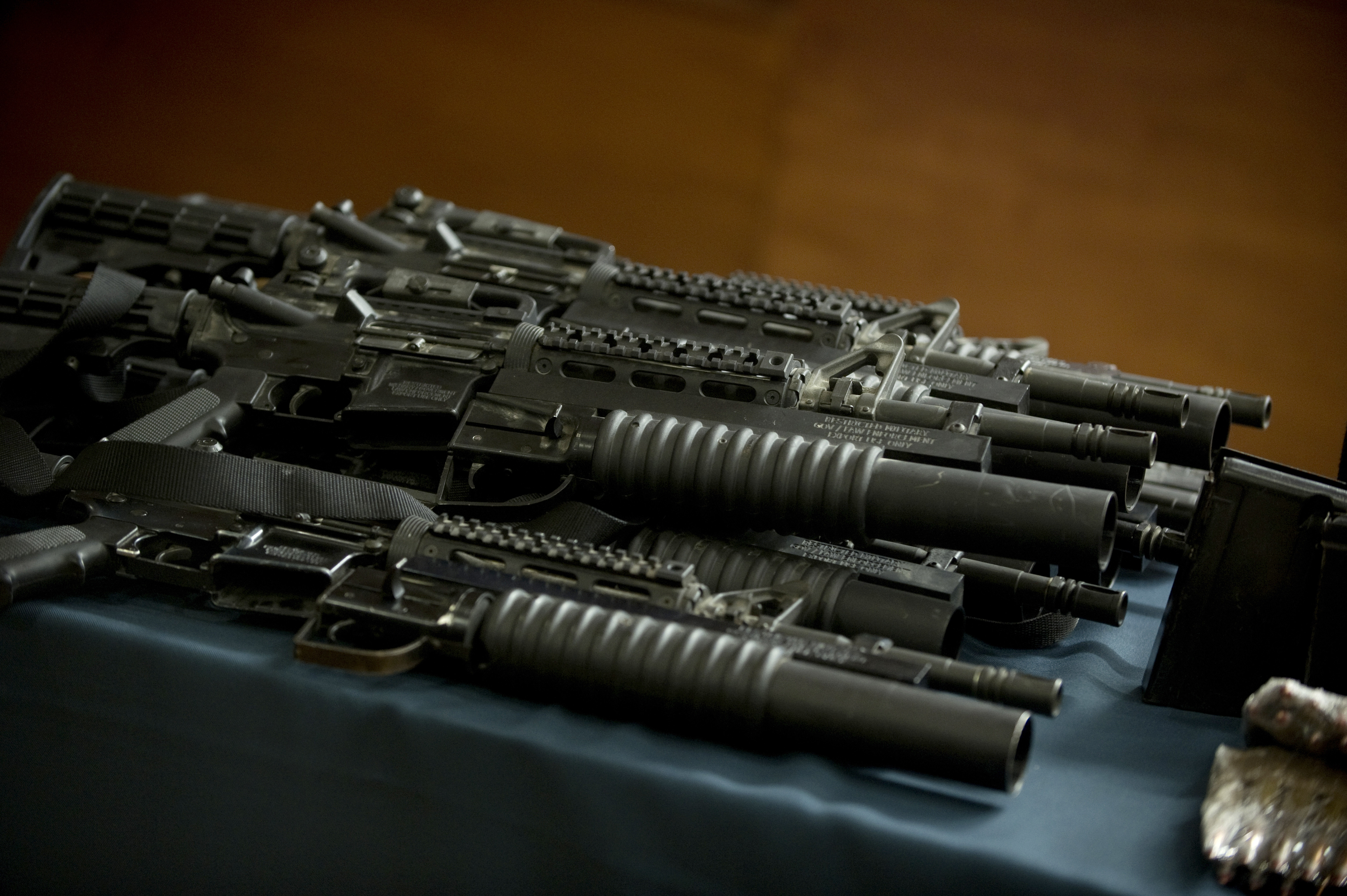 Some US made M4A1 rifles with grenade launchers, part of an arsenal seized to the leader of the drug cartel &quot;Cartel de Jalisco Nueva Generacion&quot;, Erick Valencia Salazar, are presented to the press on March 12, 2012 in Mexico City. Salazar, aka &quot;El 85&quot;, was arrested during a military operation in Guadalajara on March 9, 2012 with an arsenal of war weapons. Mexican officials have urged the United States for years to enact the type of gun control proposed by President Barack Obama, arguing that drug gangs were using US-made assault rifles in brutal turf wars. Analysts, however, say the measures unveiled on January 16, 2013 would do little to stem Mexico's wave of gangland killings for now, since drug cartels have built an arsenal of military-style guns to outgun local police. AFP PHOTO/  Yuri CORTEZ        (Photo credit should read YURI CORTEZ/AFP/Getty Images)