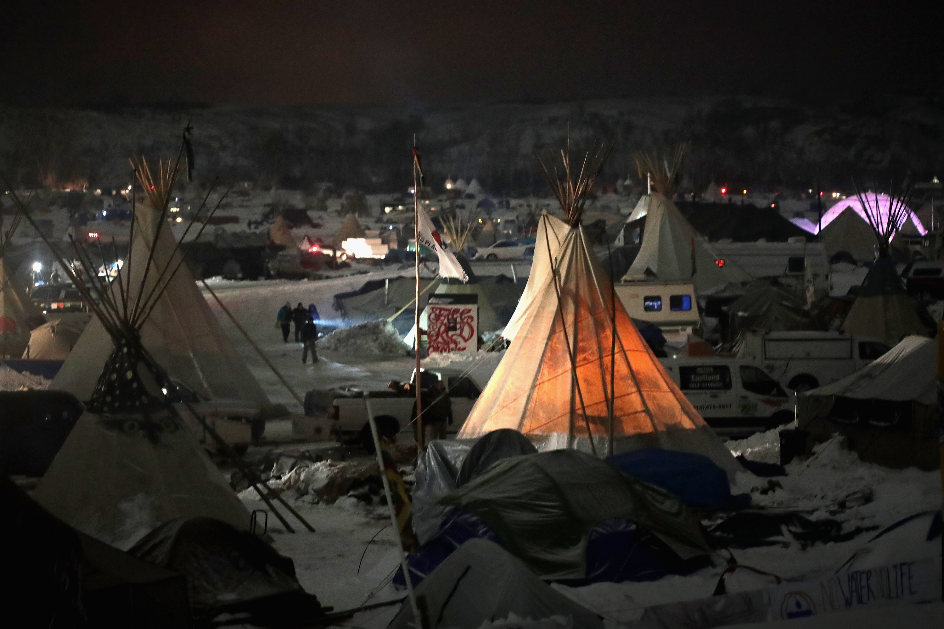 CANNON BALL, ND - DECEMBER 01:  Night falls on Oceti Sakowin Camp on the edge of the Standing Rock Sioux Reservation on December 1, 2016 outside Cannon Ball, North Dakota. Native Americans and activists from around the country have been gathering at the camp for several months trying to halt the construction of the Dakota Access Pipeline. The proposed 1,172-mile-long pipeline would transport oil from the North Dakota Bakken region through South Dakota, Iowa and into Illinois.  (Photo by Scott Olson/Getty Images)