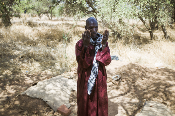 Idrissa Maiga, a Malian farmer, prays among the graves of his wife and three of his children in a cemetery behind the Konna school on January 27, 2013 who were reportedly killed by French army air strikes on January 11. Maiga's second wife, 41, and two boys and a girl aged from 10 to 14 allegedly perished on the morning of the 11th during the air raid and were buried the same afternoon.  (Photo: FRED DUFOUR/AFP/Getty Images)