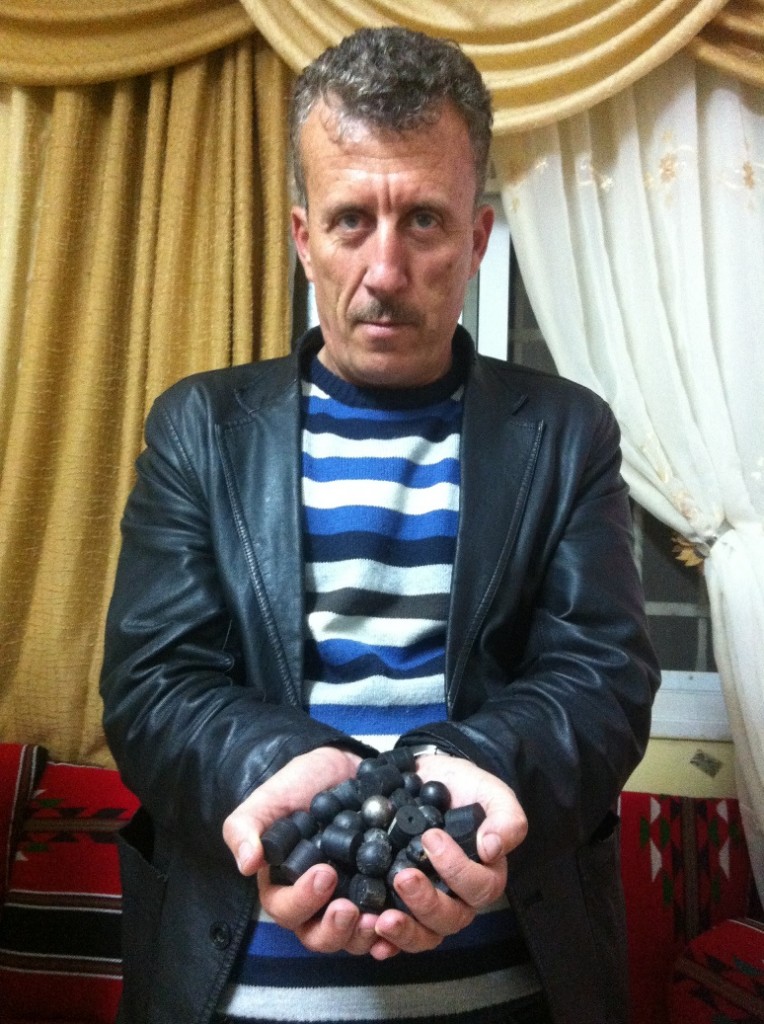 Former prisoner of conscience Bassem Tamimi holds plastic and rubber-coated bullets fired by Israeli forces.