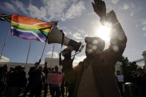A group of people from the gay, lesbian and transgender community in South Africa demonstrate outside the Parliament in Cape Town (Photo Credit: Rodger Bosch/AFP/GettyImages).