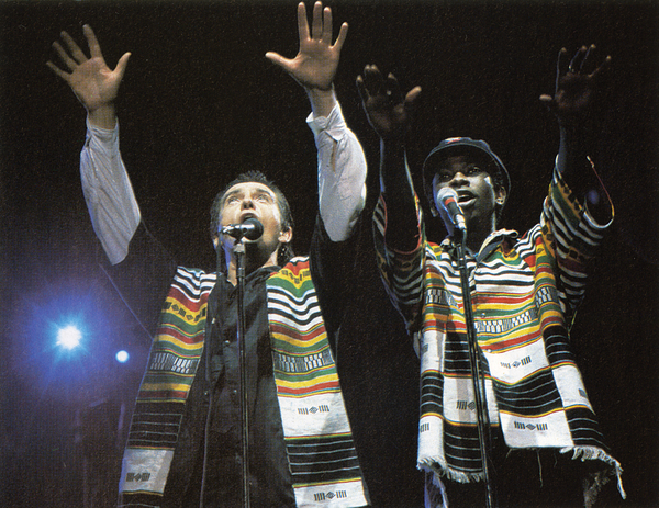 Peter Gabriel and Youssou N'Dour performing onstage at the Human Rights Now! concert (Photo Credit: Ken Regan/Neal Preston for Amnesty International).