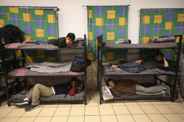  Immigrants prepare to sleep at the San Juan Bosco shelter. (Photo Credit: John Moore/Getty Images)