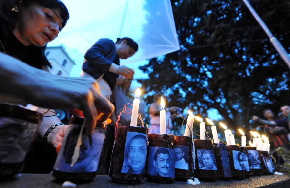 Honduran journalists take part in a vigil in memory of over 20 journalists killed in Honduras in Tegucigalpa, Honduras (Photo Credit: Orlando Sierra/AFP/GettyImages).