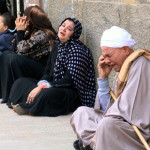 Egyptian relatives of supporters of ousted Islamist president Mohamed Morsi cry sitting outside the courthouse after the court ordered the execution of hundreds of Morsi supporters after only two hearings in March (Photo Credit: AFP/Getty Images).