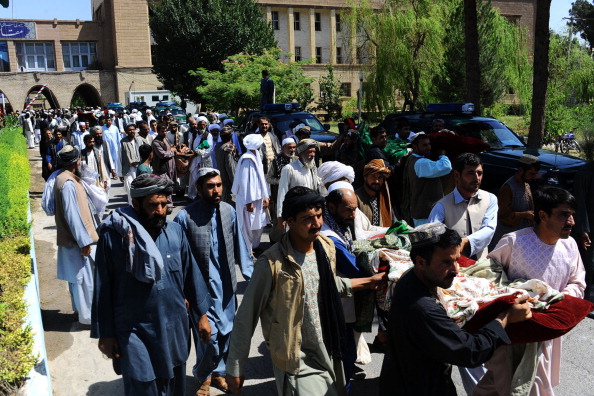 Afghan mourners and demonstrators carry the bodies of civilians allegedly killed in a NATO-led ISAF air strike in Herat on August 5, 2014. Afghan officials accused an ISAF airstrike of killing four civilians in the western province of Herat. (Photo credit: Aref Karimi/AFP/Getty Images)