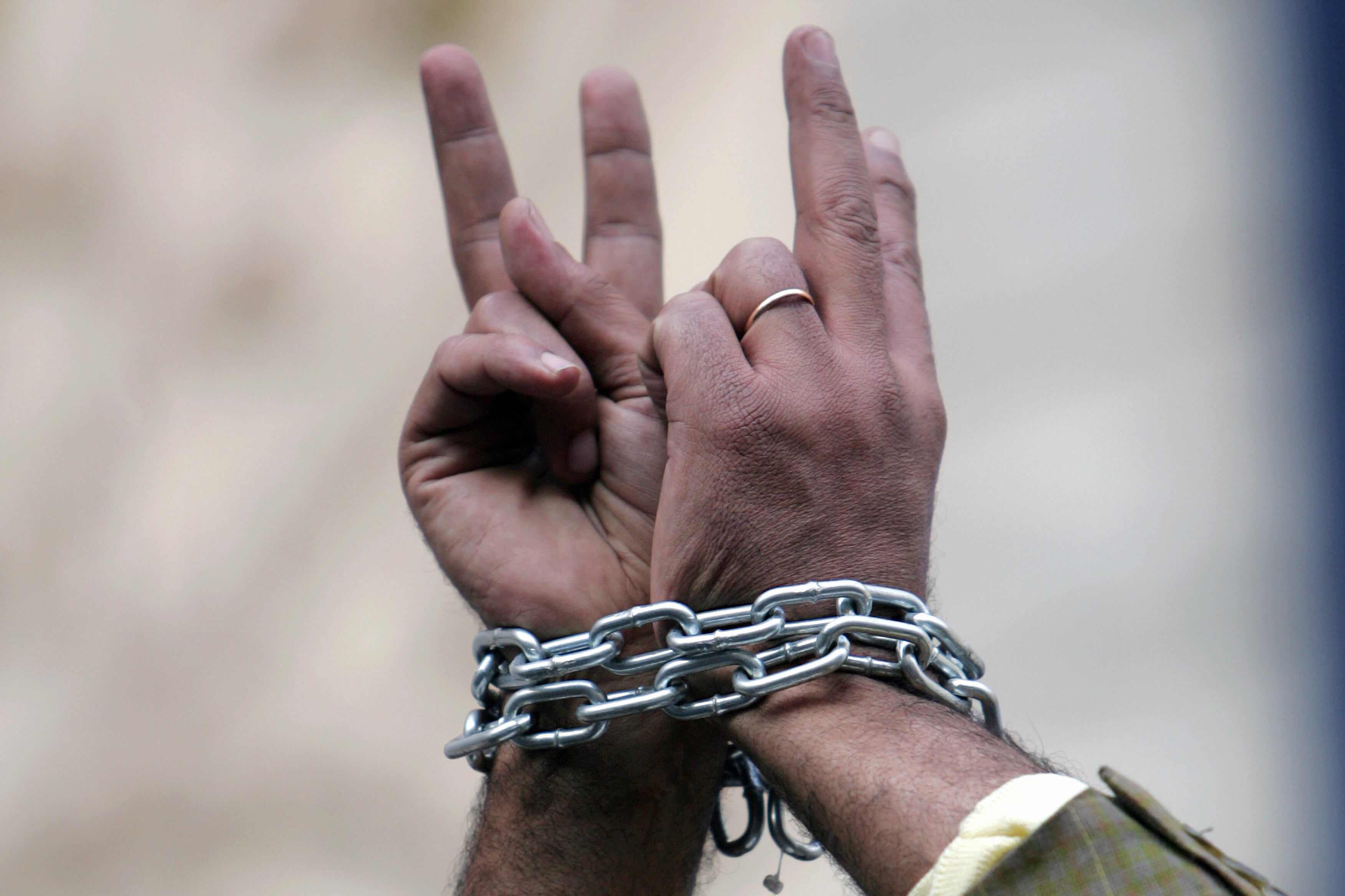 Egyptian human right activist with chained hands during a protest against torture in police stations. KHALED DESOUKI/AFP/Getty Images