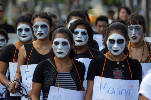 26 Nov 2014, San Salvador, El Salvador --- (141126) -- SAN SALVADOR, Nov. 26, 2014 (Xinhua) -- Women of different feminist organizations take part in a march asking for the freedom of 17 women accused of abortion, on the International Day of the Elimination of Violence Against Women, in San Salvador, capital of El Salvador, Nov. 25, 2014. United Nations figures showed that 35 percent of the women and children in the world suffer from physical or sexual violence throughout their life. And in some countries and regions, the figure goes up --- Image by © [e]LUIS GALDAMEZ/Xinhua Press/Corbis